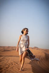 Beautiful girls in a beautiful flowing dress in desert condition