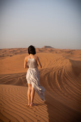 Beautiful girls in a beautiful flowing dress in desert condition
