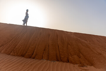 Beautiful girls in a beautiful flowing dress in desert condition