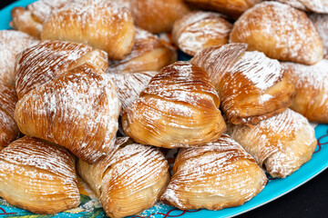 Many sfogliatella cakes on street market. Sfogliatelle puff pastry, naples bakery
