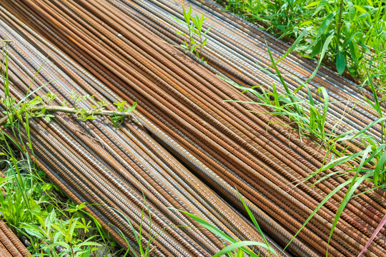 Diagonal composition of steel reinforcement bars creating geometric pattern with industrial construction materials