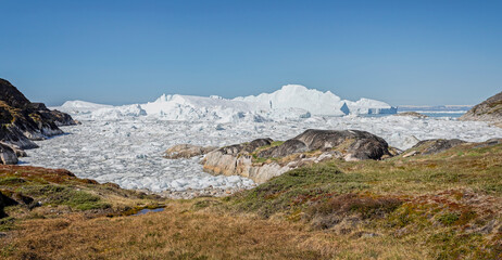 Large icebergs in the Ilulissat icefjord seen from land in Ilulissat, Greenland on 17 July 2022