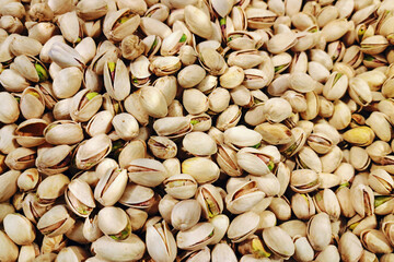 Pistachio nuts background. Natural healthy snack concept. Organic opened shells close-up. Fresh crunchy pistachios texture. Vegan protein food. Raw edible seeds. Dry roasted kernels pattern view.