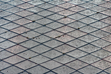 Close-up texture of grey diamond-patterned roof tiles, showcasing geometric lines and durability,