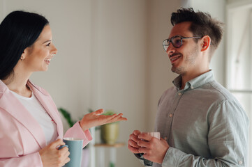 Business colleagues enjoying coffee break and engaging in friendly conversation