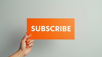 Minimalist orange subscribe sign held by a lightskinned hand against a gray background
