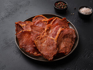 pork dried chips on a black background