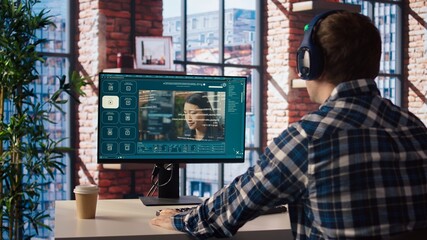 Man in home office using generative artificial intelligence website generating videos using...