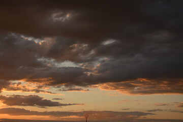Evening multi-colored sky with dark clouds
