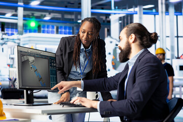 Photovoltaics factory teamworking colleagues working together to create CAD models for solar modules. Engineering team doing brainstorming, developing and optimizing solar panel designs