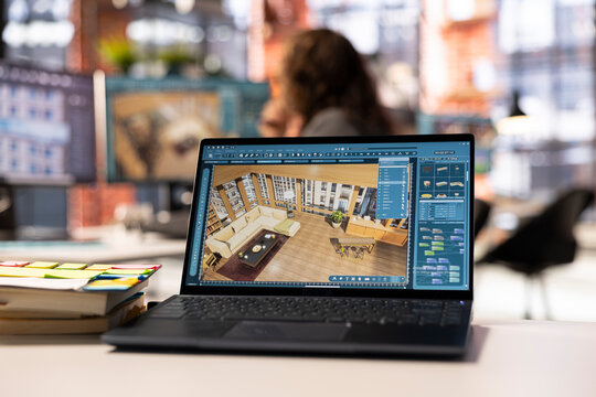 Freelancer designer decorates an apartment floor plan on a computer, using architectural software to configure elements. Woman uses interface to enable rendering and 3D modeling.
