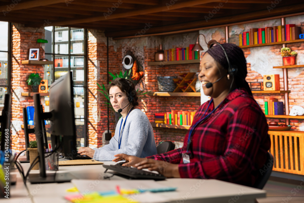Poster call center agent laughing at funny joke while talking with customer in office. customer service rep