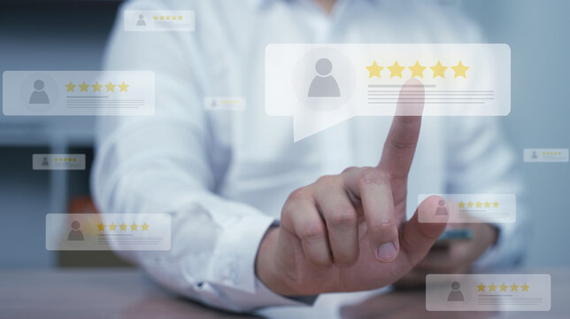 A hand pointing to a 5-star customer review icon on a virtual screen. Concept of user experience, satisfaction, feedback rating and CRM system in digital business. - Powered by Adobe