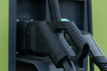 Electric Vehicle Charging Station Connectors with Handles and Green Panel