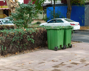 Green garbage bins on a city street