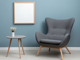 Modern living room with gray chair, table, flowers, and framed blank art