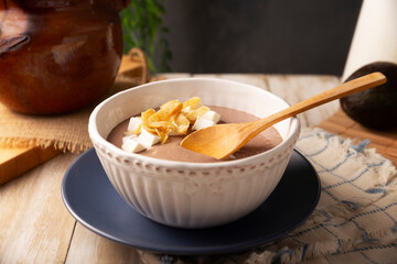 Creamy bean soup. In Mexico known as Crema de Frijoles, a very easy and nutritious homemade food recipe, commonly accompanied with cheese, cream, avocado and corn tortilla cut into strips and fried.