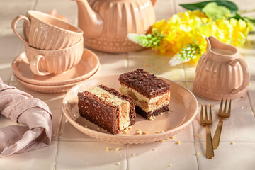Tasty sponge cake with glaze and cream layer.