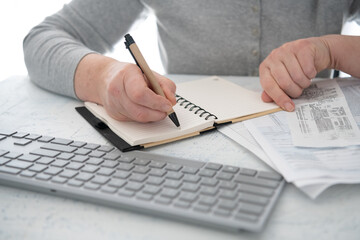 Tax return filing. A woman fills out a tax form.