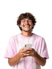 Smiling curly haired young man holds a phone and appears happy while wearing glasses He is wearing a pink tie dye shirt and seems to be reacting to something humorous on the screen