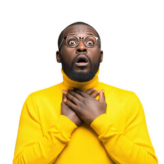 Shocked African man in yellow turtleneck sweater looks up with a surprised face holding his throat wearing glasses expressing fear and bewilderment on black backdrop