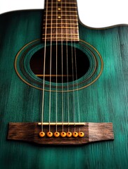 Obraz premium close-up of a teal acoustic guitar showing strings, wooden bridge, and soundhole with warm lighting highlighting texture