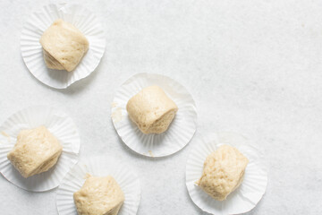 Overhead view of steamed bun dough on a white countertop, top view of mantou dough, process of making steamed milk buns