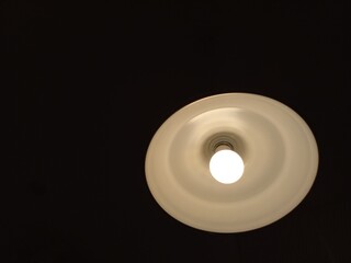 A lamp that lights up in the darkness, becomes a symbol of a figure that illuminates the surroundings