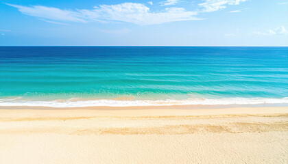 Obraz premium Crystal-clear turquoise waters gently touch the soft sandy shore under a bright blue sky filled with fluffy white clouds, creating a perfect tropical paradise scene.