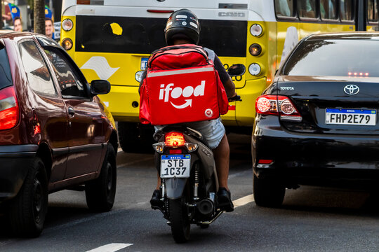 Marilia, Sao Paulo, Brazil, September 09, 2024. Worker ifood on the motorcycle delivers food to customers in downtown of Marilia city.