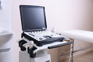 Modern ultrasound machine and examination bed in clinic