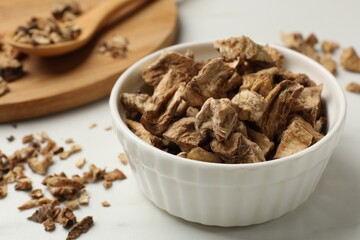 Pieces of dry chicory roots on white table, closeup