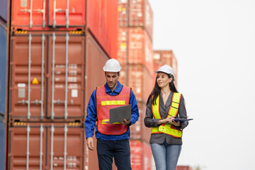Foreman dock workers checking containers box at shipping yard, Logistics workers at shipping port...