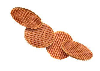 Yummy Dutch waffles (stroopwafels) flying on white background