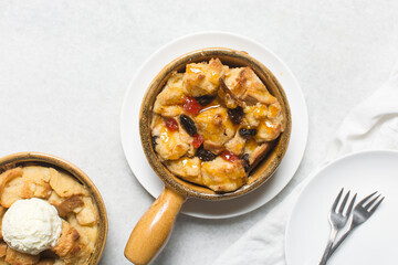 Overhead view of homemade bread pudding with raisins, top view of fresh bread pudding with raisins on a white background