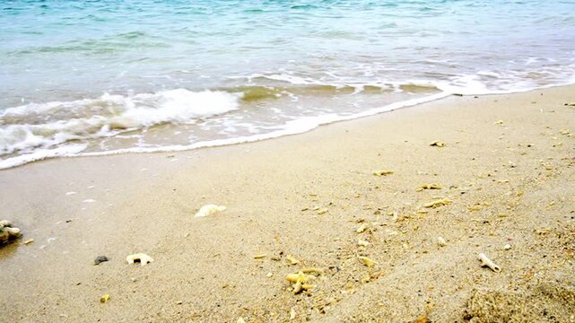 Small waves lapping a sandy beach under a breeze in Okinawa