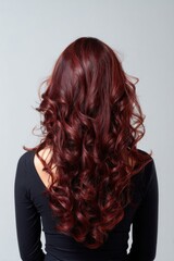 Naklejka premium A woman with long red hair is wearing a black shirt