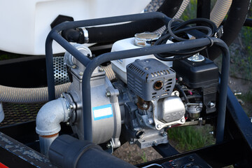 Fototapeta premium Gas powered water pump mounted on tongue of trailer.