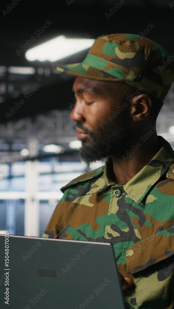 Poster vertical video army it specialist in data center using laptop to defend networks against cyber threa