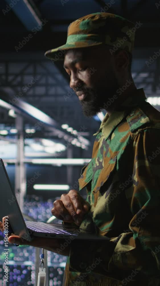 Poster vertical video army it specialist in data center using laptop to defend networks against cyber threa