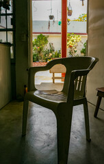 White plastic chair patio, solitary chair courtyard, minimalist furniture contrast