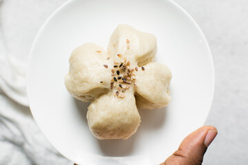 Overhead view of steamed bun, top view of mantou on a white background, process of making steamed milk buns
