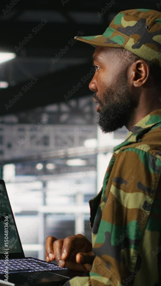 Poster vertical video soldier in server room uses geospatial data to support evacuation during emergency op