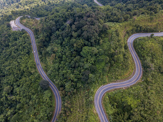Aerial view of the road cutting through mountains on the way from Phayao province to Nan province,...