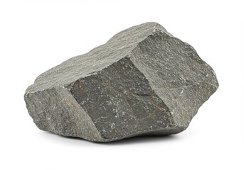 Close up view of a dark gray stone with a rough texture on a white backdrop