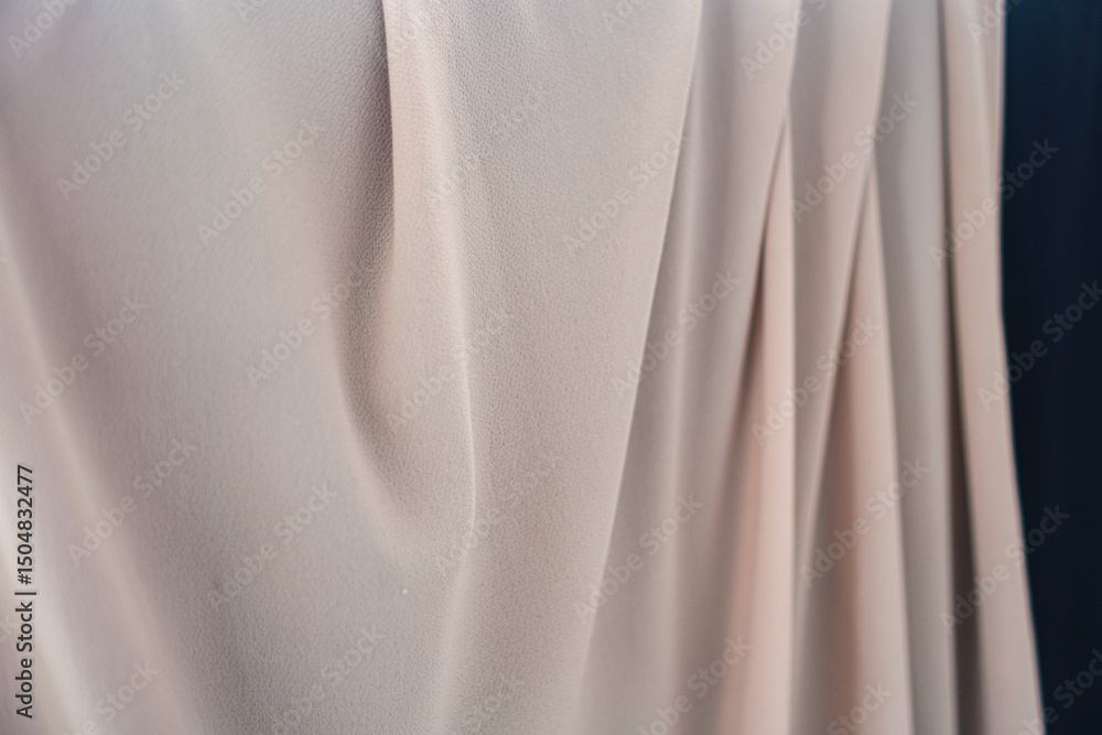 Aufkleber close-up showcases elegant fabric in soft, neutral tones and graceful folds. the delicate texture an