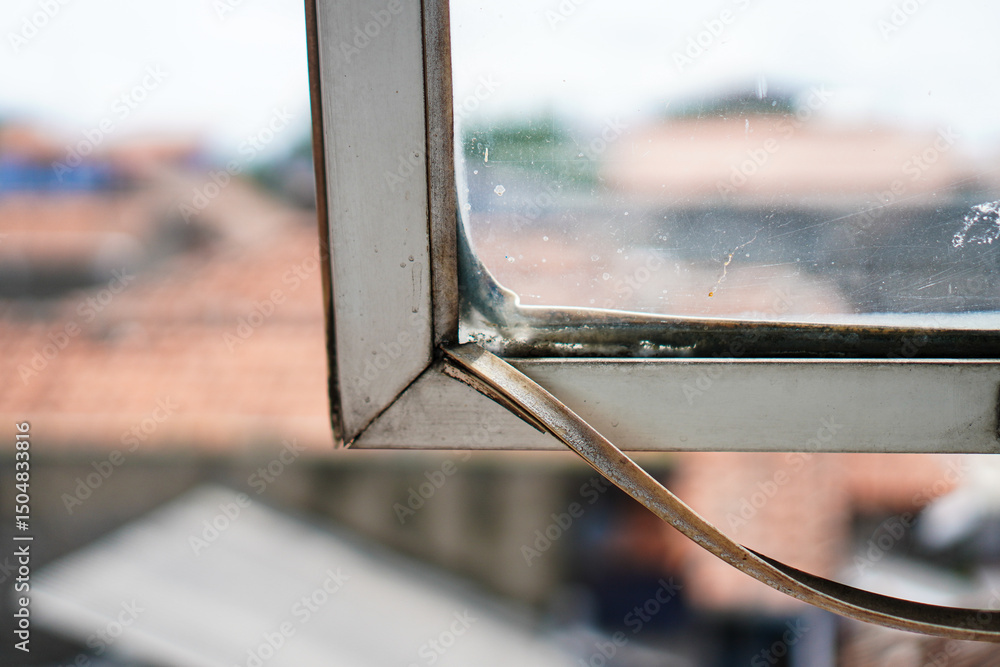 Poster aged window frame displaying weathering and texture, creating a nostalgic and raw aesthetic. the blu