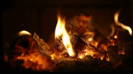 Warm glowing embers burning brightly in fireplace fire wood ash heat flames orange yellow light cozy winter home comfort relaxation. 4k vidios - Powered by Adobe