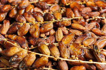 An artistic full-frame shot showcases the rich textures and natural beauty of fresh dates on their...