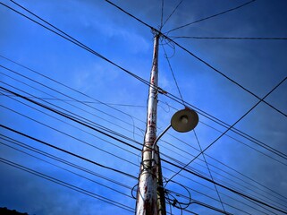 mast and wires, electric cable pole with lights against sky background